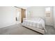 Bright bedroom features a sliding barn door to the bathroom and neutral decor at 717 Monroe Hill Pl, Henderson, NV 89011