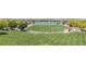 Picturesque community park with lush green lawns, a lake, walking paths, and mature trees at 717 Monroe Hill Pl, Henderson, NV 89011