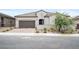 Charming single-story home featuring a tile roof, manicured landscaping, and a two-car garage at 717 Monroe Hill Pl, Henderson, NV 89011