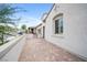 Side view of the house with a paved patio entrance leading to the front door, with privacy wall at 717 Monroe Hill Pl, Henderson, NV 89011