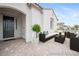 Cozy staged front porch with neutral furniture and a dark front door at 717 Monroe Hill Pl, Henderson, NV 89011