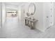 Bright hallway featuring wood-look flooring, accented by a table and mirror creating a welcoming atmosphere at 717 Monroe Hill Pl, Henderson, NV 89011