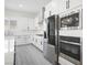 Contemporary kitchen featuring white cabinetry, stainless steel appliances, and stylish backsplash at 717 Monroe Hill Pl, Henderson, NV 89011