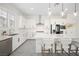 Bright kitchen with stainless steel appliances, pendant lighting, white countertops and a large island at 717 Monroe Hill Pl, Henderson, NV 89011