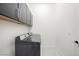 Clean laundry room features modern appliances and black cabinets for ample storage at 717 Monroe Hill Pl, Henderson, NV 89011
