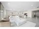 Bright open-concept living space with modern white kitchen, sleek marble coffee table and neutral color palette at 717 Monroe Hill Pl, Henderson, NV 89011