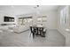 Open concept living space with dining area, modern decor, and ample natural light at 717 Monroe Hill Pl, Henderson, NV 89011
