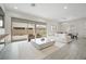 Neutral living room featuring a large sliding glass door to the backyard and an adjacent dining area at 717 Monroe Hill Pl, Henderson, NV 89011