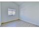 Bright bedroom with wood-look flooring, a window, and fresh white walls at 7405 Saybrook Point Dr, Las Vegas, NV 89128