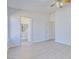 Spacious bedroom showing bathroom entry, wood-look floors, ceiling fan, and neutral walls at 7405 Saybrook Point Dr, Las Vegas, NV 89128