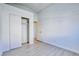 Clean bedroom with wood-look flooring, closet, and a neutral color scheme at 7405 Saybrook Point Dr, Las Vegas, NV 89128