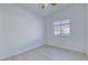 Bright bedroom with new flooring, a ceiling fan, and a large window at 7405 Saybrook Point Dr, Las Vegas, NV 89128