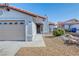 Single-Gathering home featuring a two-car garage, rock landscaping, and a welcoming front entrance at 7405 Saybrook Point Dr, Las Vegas, NV 89128