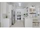 Bright kitchen featuring white cabinetry, stainless steel appliances, marble countertops, and a modern design at 7405 Saybrook Point Dr, Las Vegas, NV 89128