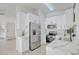 Well-lit kitchen featuring white cabinets, stainless appliances, marble countertops, and an open design at 7405 Saybrook Point Dr, Las Vegas, NV 89128