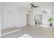 Bright living room with new flooring leading into an open kitchen and other rooms at 7405 Saybrook Point Dr, Las Vegas, NV 89128