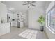 An open concept living space features white cabinets, stainless steel appliances, and a large window at 7405 Saybrook Point Dr, Las Vegas, NV 89128
