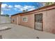 Backyard area has cement and stucco exterior, a barred window and a white-painted door at 75 N 27Th St, Las Vegas, NV 89101