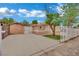 A lovely single story home with a well-maintained lawn, mature trees, and a gated driveway at 75 N 27Th St, Las Vegas, NV 89101