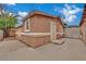 Exterior view with a stucco finish, white trim, secure door, and a cement walkway at 75 N 27Th St, Las Vegas, NV 89101