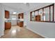Kitchen area with tiled floors and wooden cabinets with black countertops at 75 N 27Th St, Las Vegas, NV 89101