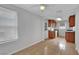 Kitchen area with tile flooring, wooden cabinets and access to door at 75 N 27Th St, Las Vegas, NV 89101