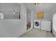A clean laundry area offers tile floors, white walls, and modern washer and dryer units at 75 N 27Th St, Las Vegas, NV 89101