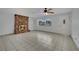 Bright living room featuring a striking stone fireplace, tile floors, a ceiling fan, and a large window at 75 N 27Th St, Las Vegas, NV 89101