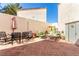 Spacious backyard with stylish patio furniture and a well-maintained brick paved area at 8860 Hampton Green Ave, Las Vegas, NV 89129