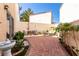 Spacious backyard with stylish patio furniture and a well-maintained brick paved area at 8860 Hampton Green Ave, Las Vegas, NV 89129