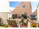 Outdoor patio features wicker furniture, a manicured garden, and a charming two-story house facade at 8860 Hampton Green Ave, Las Vegas, NV 89129
