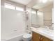 Bathroom with a shower-tub, a toilet, and a vanity with a sink and mirror at 8860 Hampton Green Ave, Las Vegas, NV 89129