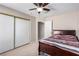 Bedroom with ceiling fan and a closet with sliding doors and a bed with a colorful striped pattern at 8860 Hampton Green Ave, Las Vegas, NV 89129