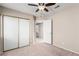 Bedroom featuring a ceiling fan, a closet with sliding doors and a bed with a colorful striped pattern at 8860 Hampton Green Ave, Las Vegas, NV 89129