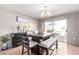 Cozy dining area featuring a modern table set with chairs, a bench, and sliding glass doors leading outside at 8860 Hampton Green Ave, Las Vegas, NV 89129