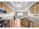 Open kitchen layout with granite countertops, stainless appliances, and adjoining dining area at 8860 Hampton Green Ave, Las Vegas, NV 89129