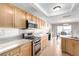 Bright and modern kitchen with stainless steel appliances and tiled flooring at 8860 Hampton Green Ave, Las Vegas, NV 89129