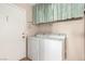 Laundry area featuring a washer, dryer, and a decorative curtain at 8860 Hampton Green Ave, Las Vegas, NV 89129