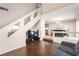 Bright living room with hard wood floors, gray sofa and a seamless transition to the dining area at 8860 Hampton Green Ave, Las Vegas, NV 89129
