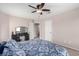 Well-lit bedroom with carpet floors, a ceiling fan, vanity, and two doors at 8860 Hampton Green Ave, Las Vegas, NV 89129