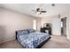 Relaxing bedroom boasts carpeted floors, ceiling fan, and a dark wood vanity at 8860 Hampton Green Ave, Las Vegas, NV 89129
