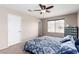 Comfortable main bedroom featuring carpet floors, a ceiling fan, and a bright window at 8860 Hampton Green Ave, Las Vegas, NV 89129