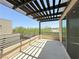 Outdoor balcony with a pergola, offering a shaded seating area with a view at 10879 Artesano Ave, Las Vegas, NV 89135