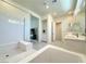 Bright bathroom featuring a soaking tub, glass shower, and dual vanity sinks at 10879 Artesano Ave, Las Vegas, NV 89135