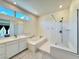Bright bathroom with double sink vanity, soaking tub, glass shower, and modern fixtures at 10879 Artesano Ave, Las Vegas, NV 89135