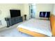 Cozy bedroom featuring carpet, modern decor, and plenty of natural light at 10879 Artesano Ave, Las Vegas, NV 89135