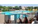Community pool and spa area with lounge chairs and umbrellas at 10879 Artesano Ave, Las Vegas, NV 89135