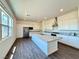 Bright kitchen with an island, black stainless steel appliances, granite counters, and modern finishes at 10879 Artesano Ave, Las Vegas, NV 89135