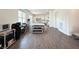 Bright living space with wood-look tile floors, large windows, and access to the kitchen at 10879 Artesano Ave, Las Vegas, NV 89135