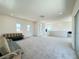 Large, airy living room with multiple windows and access to an outdoor balcony at 10879 Artesano Ave, Las Vegas, NV 89135